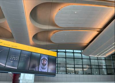 Giant screens were spread across the terminal displaying portraits of the astronaut with messages welcoming him home. Khushnum Bhandari / The National