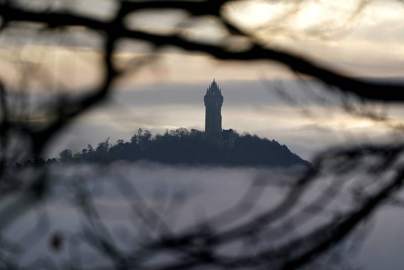 On Tuesday wintery weather spread across the UK, with the Wallace Monument rising out of heavy ground fog in Stirling, Scotland. PA