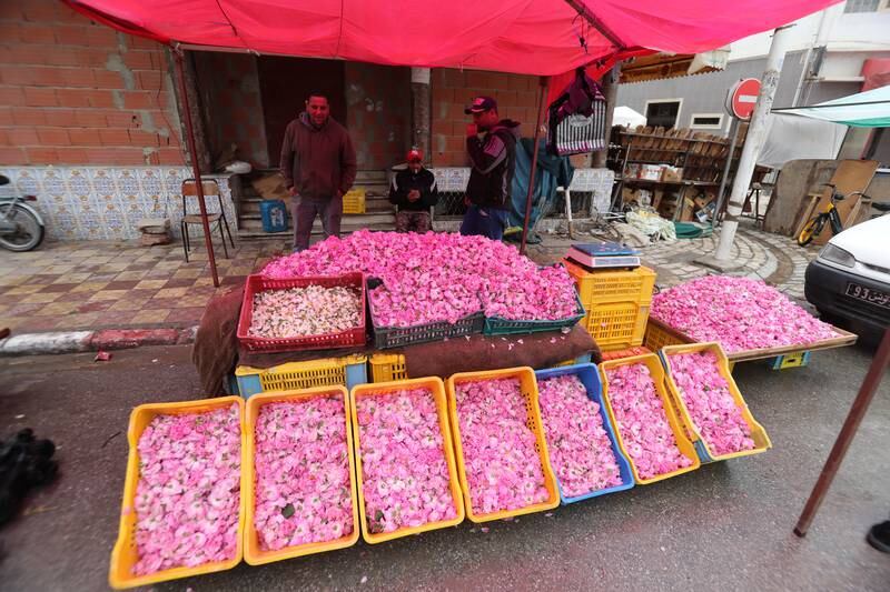 A vendor sells rose petals.