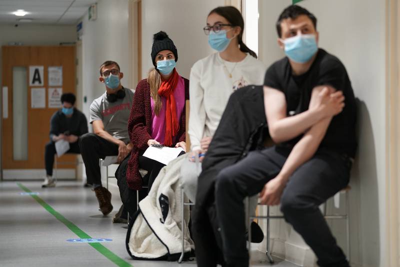 People wait to receive a Covid-19 vaccine doses during a 24-hour “jabathon” in Haringey, London. PA