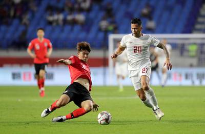 DUBAI , UNITED ARAB EMIRATES , January  7 – 2019 :- Kim Minjae ( no 4 in red ) of Korea Republic and Javier Patino ( no 20 in white ) of Philippines in action during the AFC Asian Cup UAE 2019 football match between KOREA REPUBLIC vs. PHILIPPINES held at Al-Maktoum Stadium in Dubai. Korea Republic won the match by 1-0. ( Pawan Singh / The National ) For News/Sports