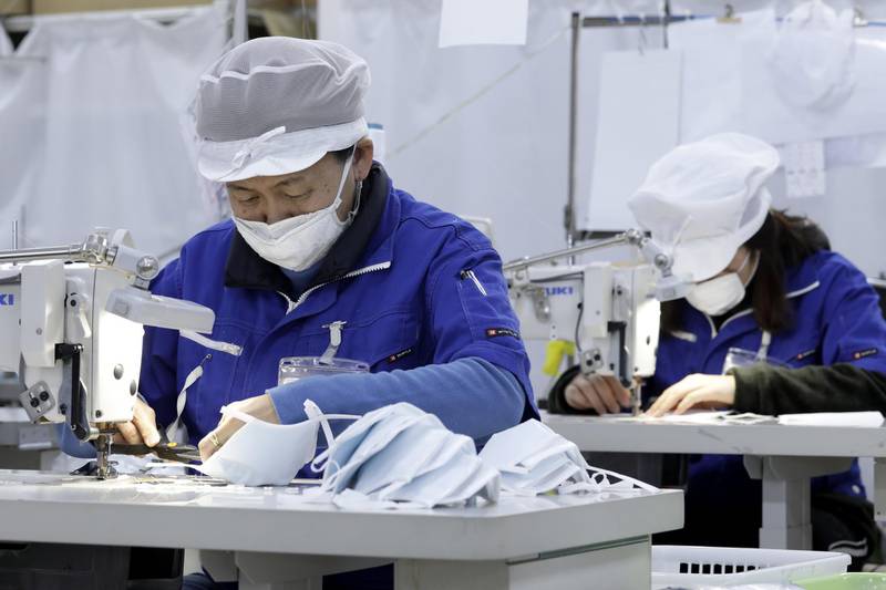 Employees work during the manufacturing of reusable protective masks at the Clever Co. factory in Toyohashi, Aichi Prefecture, Japan. Bloomberg