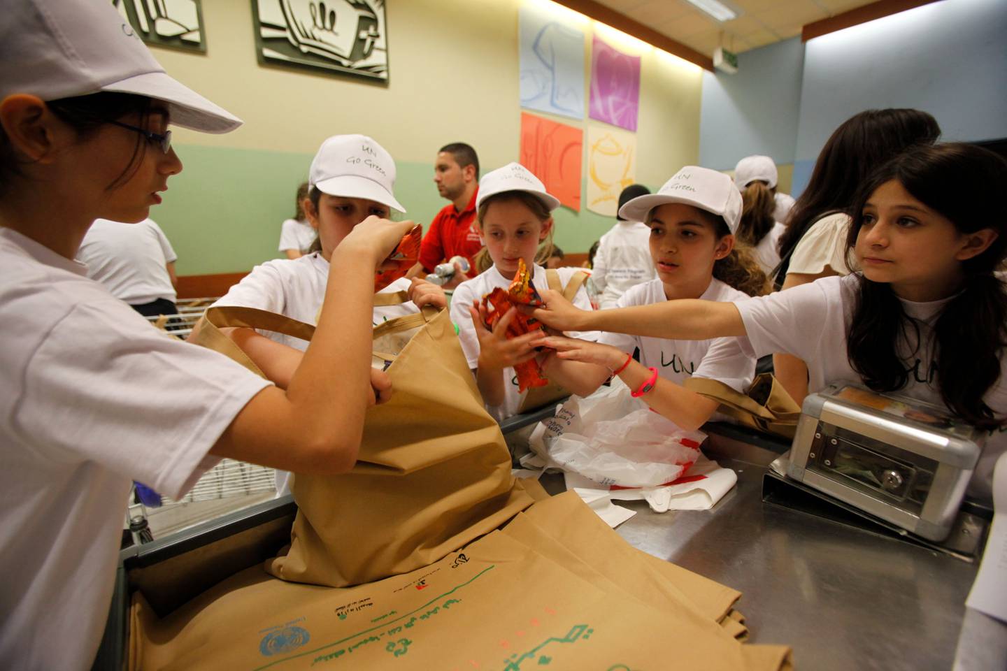 School children help in distributing Fabric bags in a super market during the UN launching of an awarness campaign to replace the flimsy disposable grocery-store-style plastic bags with fabric ones, in Amman, Jordan on June 03, 2010. (Salah Malkawi for The National) 