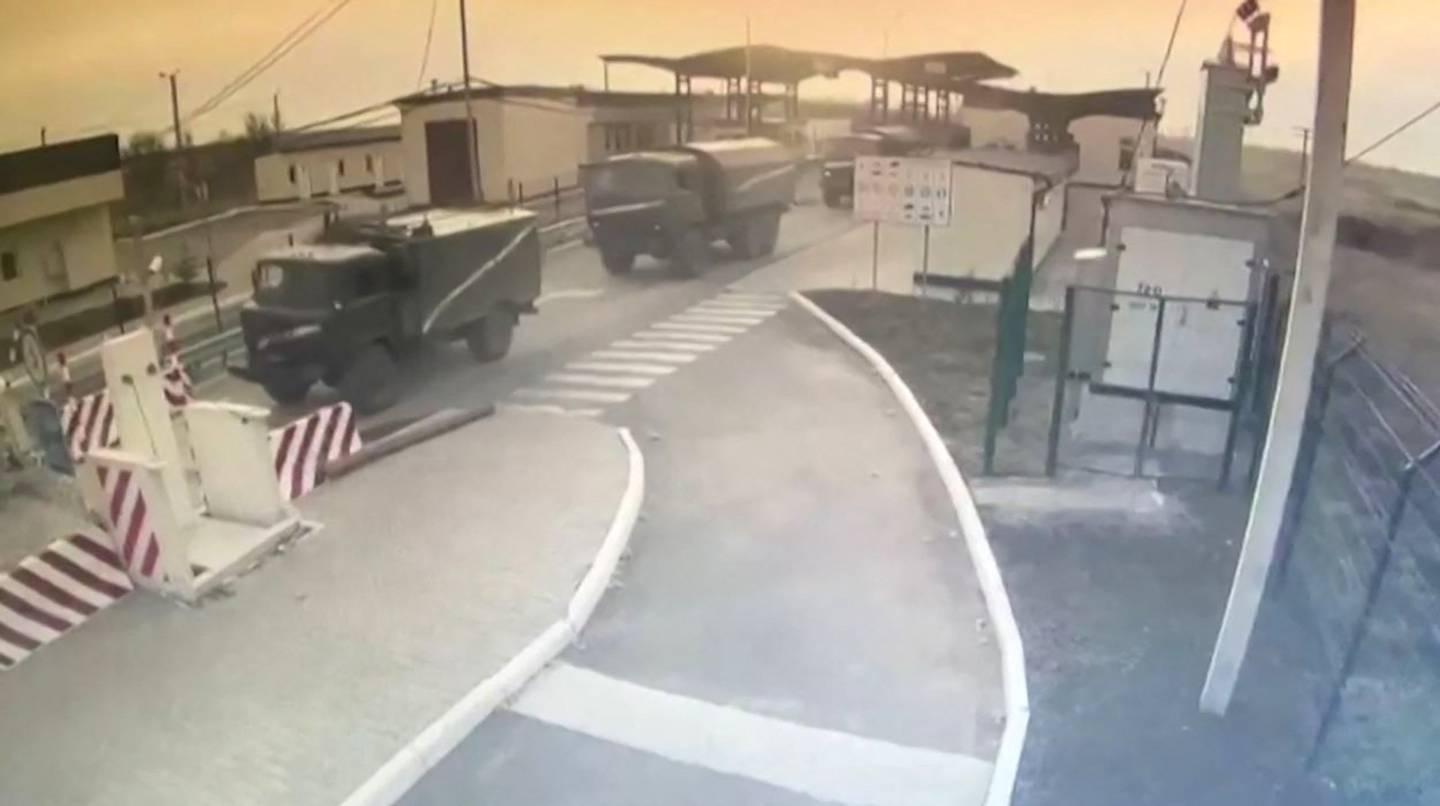 CCTV footage of Russian military equipment crossing a Crimea border checkpoint on February 24, 2022. AFP
