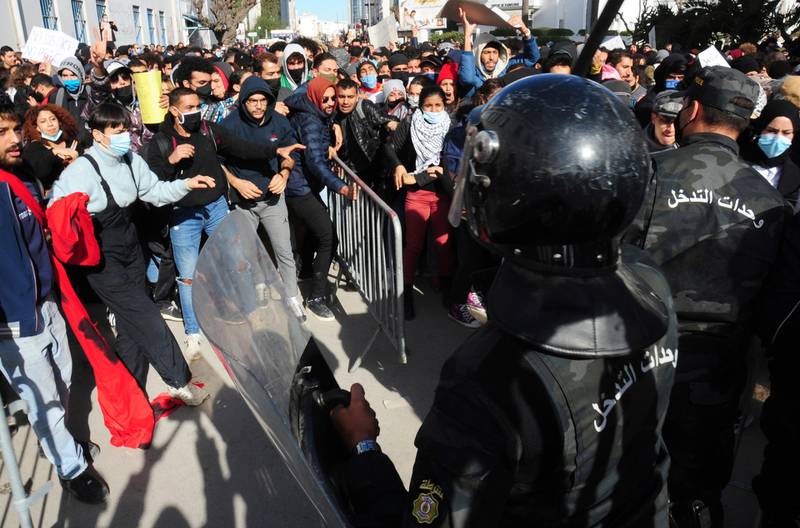 Protesters face police officers during a demonstration in Tunis. AP