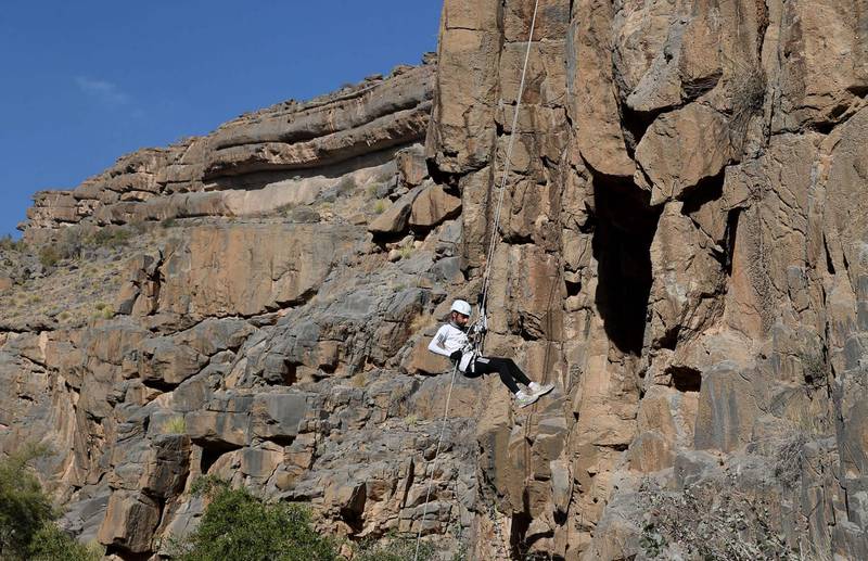 A man rappels down a mountain near the village of Misfat Al Abriyeen, which is popular among people seeking adventure in Oman. AFP