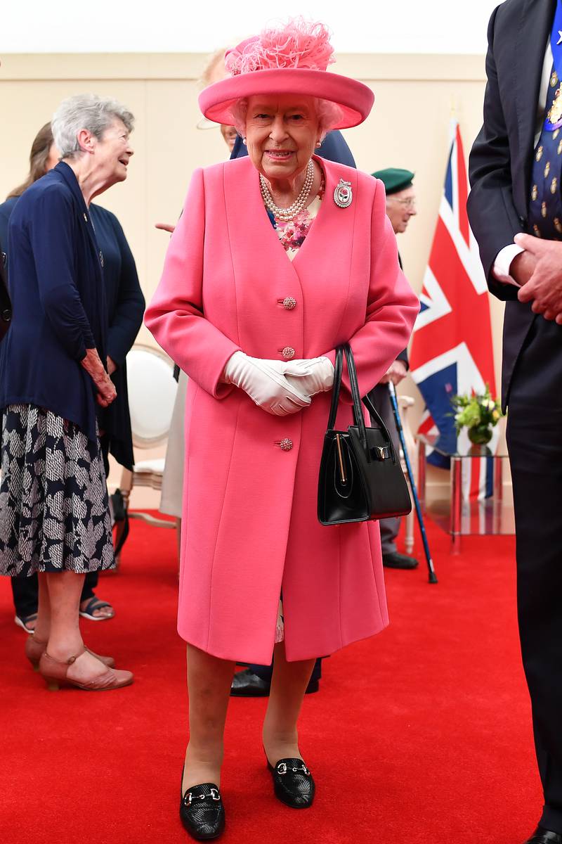 Queen Elizabeth II, wearing pink, meets veterans during the D-Day 75 Commemorations on June 05, 2019, in Portsmouth, England. Getty Images