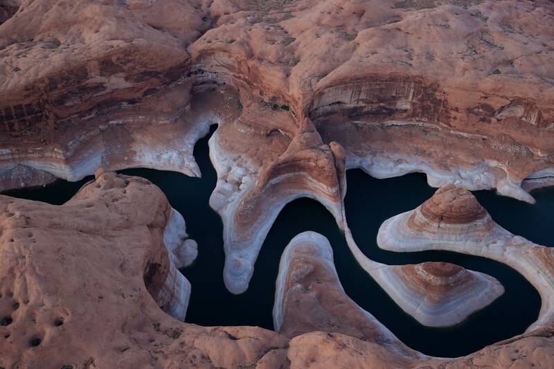The tall bleached 'bathtub ring' is visible on the rocky banks of Lake Powell at Reflection Canyon in Utah, as severe drought grips parts of the western US. Getty Images