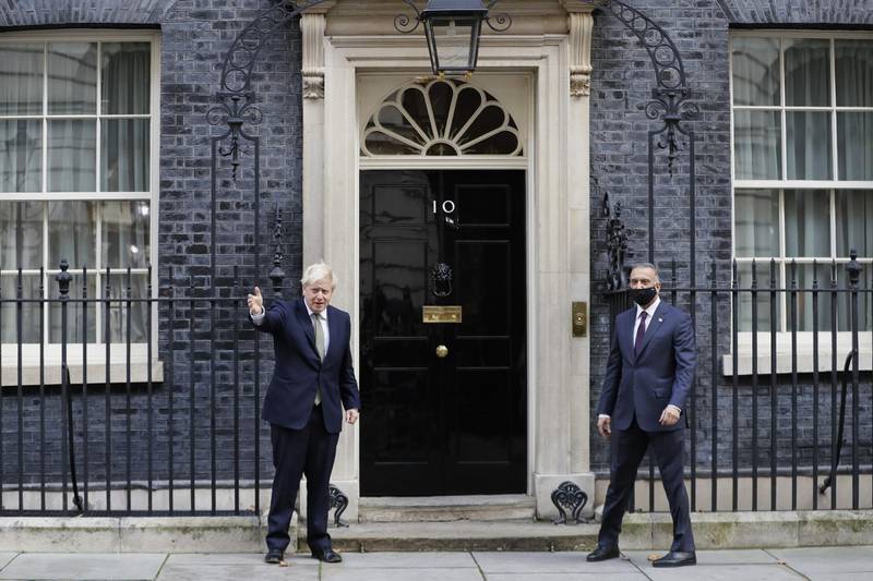 Britain's Prime Minister Boris Johnson, left, welcomes the Prime Minister of Iraq, Mustafa Al Kadhimi to Downing Street in London. AP Photo
