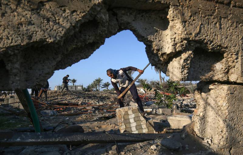 A Palestinian man clears rubble from a building, damaged by an Israeli airstrike launched in response to rocket fire, in Khan Yunis in the southern Gaza Strip on November 2, 2019. Dozens of strikes hit the Palestinian enclave in the early hours today, targeting bases of the strip's Islamist rulers and allied groups, a security source in Gaza said.
 / AFP / SAID KHATIB
