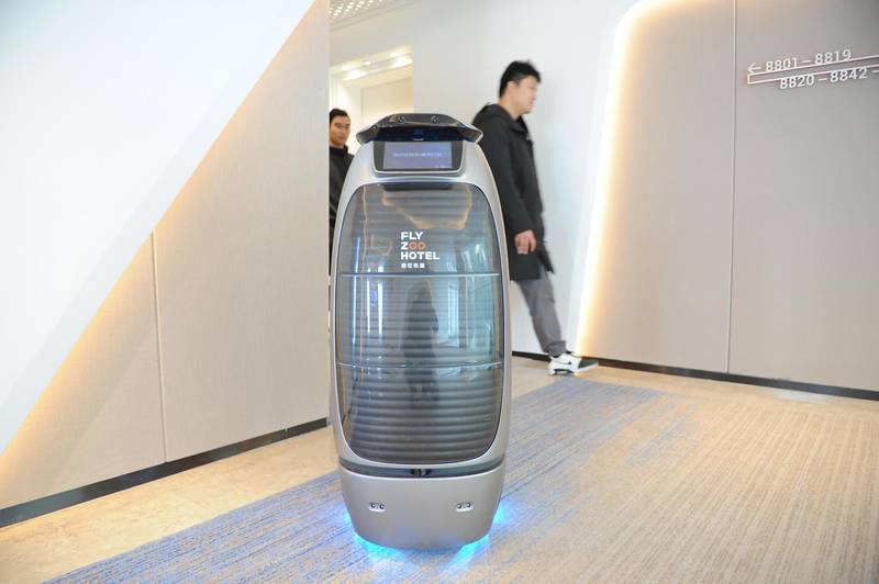 HANGZHOU, CHINA - DECEMBER 17: An intelligent robot serves at Alibaba's first future hotel on December 17, 2018 in Hangzhou, Zhejiang Province of China. Guests living in Alibaba's future hotel can walk into guest rooms, fitness center or restaurant via facial recognition system. Robots are also available in the hotel to provide recorded voice messages and accompany guests during their stay. (Photo by Zhang Yin/China News Service/VCG via Getty Images)