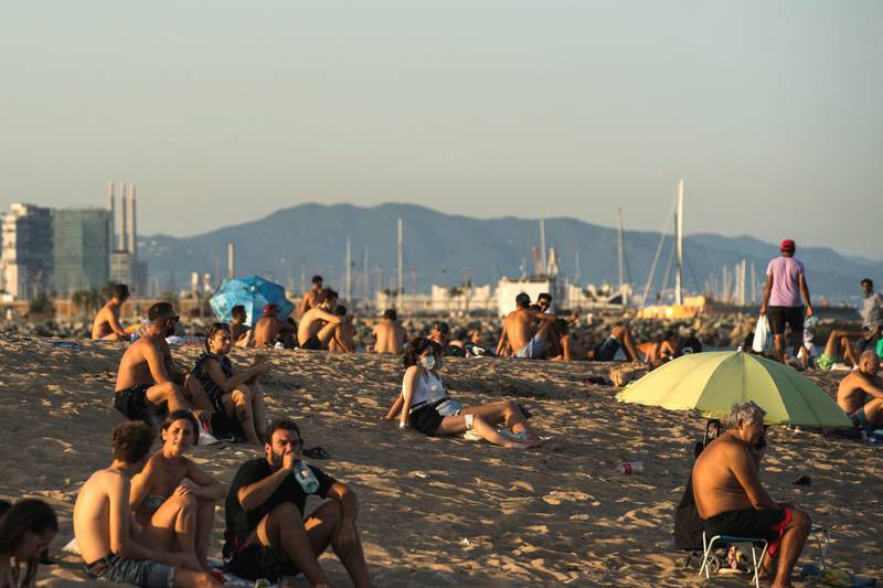 BARCELONA, SPAIN - JULY 27: People gather at La Barceloneta on July 27, 2020 in Barcelona, Spain. Spanish officials insisted it was still safe to travel to the country despite a recent rise in coronavirus (COVID-19) cases, which led the UK government to reimpose a 14-day quarantine on arrivals from Spain. The Catalonian government had recently issued a stay-at-home recommendation that included the regional capital, Barcelona. (Photo by Cesc Maymo/Getty Images)