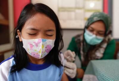 A pupil receives a dose of the Sinovac vaccine at a primary school in Tangerang, Indonesia. EPA