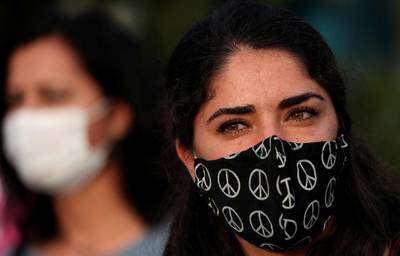 A demonstrator wearing a protective mask with peace symbols takes part in a gathering in solidarity with the jailed pro-Kurdish Peoples' Democratic Party (HDP) lawmaker Leyla Guven in Istanbul, Turkey. Reuters