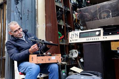 Hemmou repairs a record player in front of his shop. He is entirely self-taught