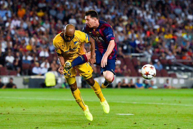 Apoel's Carlao, left, challenges Barcelona's  Lionel Messi during their Uefa Champions League match at Camp Nou. Barcelona won 1-0. David Ramos / Getty Images