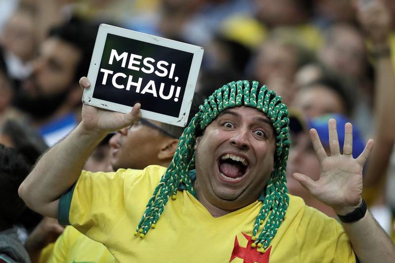 A Brazil fan holds a placard that reads 'goodbye Messi'. EPA