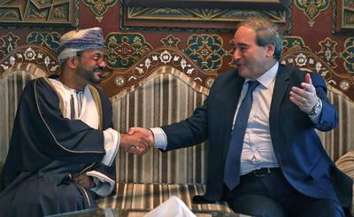 Syria's Foreign Minister Faisal Al Mekdad, right, spoke with Oman's Foreign Minister Sayyid Badr Al Busaidi in Damascus on Monday.  AFP