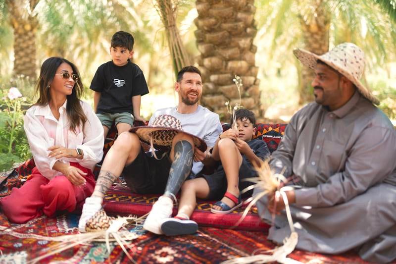 Lionel Messi, Saudi Tourism brand ambassador, and his family watch a palm-weaving exhibition before trying it themselves. Saudi Tourism Authority