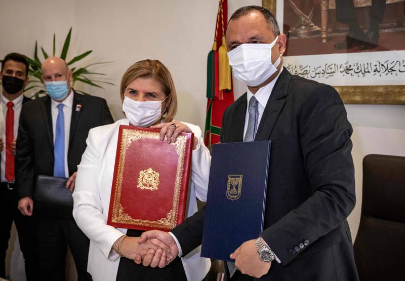 Ryad Mezzour, Morocco's Industry and Trade Minister, shakes hands with Orna Barbivai,  Israel's Economy Minister after signing a trade agreement between the two countries in Rabat. AFP