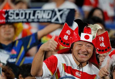 A Japan fan cheers on his team against Scotland. AP Photo