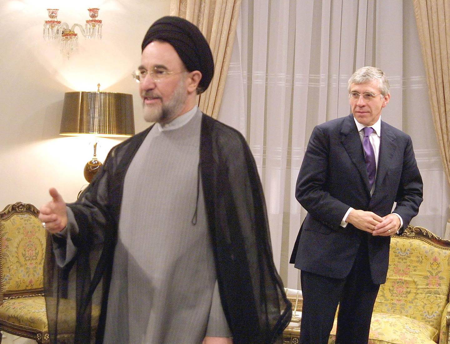 Iranian President Mohammad Khatami (L) gestures after receiving British Foreign Secretary Jack Straw at his office in Tehran 25 September 2001. Straw, the most senior British official to visit Iran since the Islamic revolution in 1979, said that he was carrying no message from the United States as it prepares for military action against Afghanistan. (Photo by ATTA KENARE / AFP)