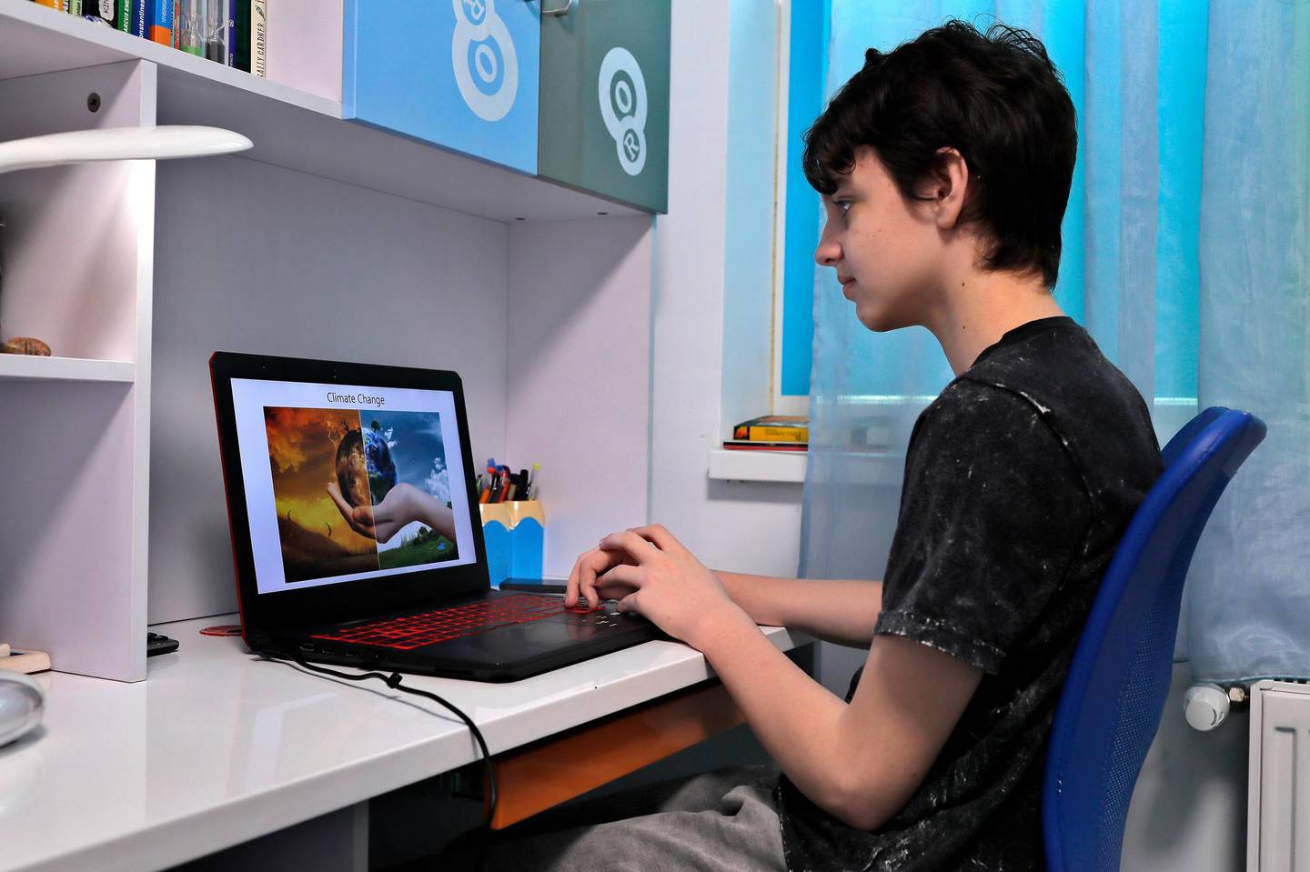 epa08375918 Romanian school student Mihai, 15, makes the final adjustments on his slideshow ahead of the Earth Day 50 global online event, in his family flat in Bucharest, Romania, 21 April 2020. Mihai will join the online Earth Day 'digital storm' by sharing a short story and a slideshow he specially made for this occasion. Earth Day, first time celebrated in 1970, is an annual event celebrated around the world on 22 April to demonstrate support for environmental protection, and now is globally coordinated by the Earth Day Network (EDN), which is active in about 193 countries. This year, to mark 50 years of celebrating Earth Day, EDN supporters around the globe are asked to flood the digital landscape with global conversations, calls to action, performances, video teach-ins and more.  EPA/ROBERT GHEMENT