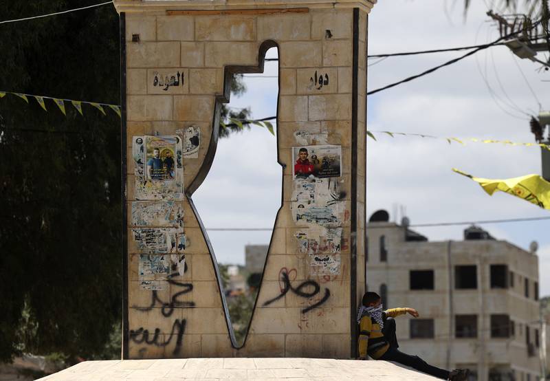 A Palestinian boy walks past a monument showing a map of Mandatory Palestine in the West Bank town of Jenin in the north of the occupied West Bank in April 2022. AFP