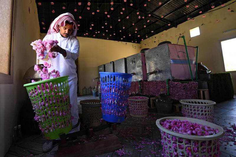 Salman weighs roses during the distillation process. AFP