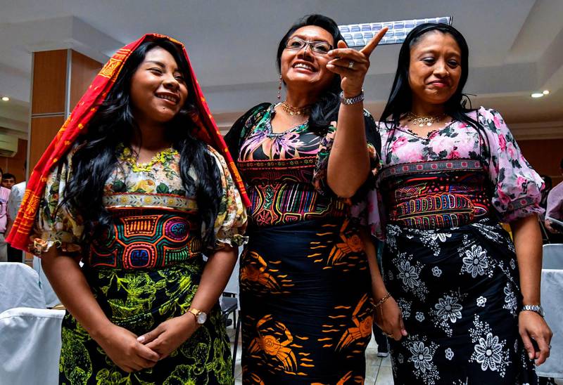 Panama's Guna Yala indigenous women wearing Molas (Guna's hand made textile) attend a press conference in Panama City, on May 21, 2019. Representatives of natives Guna requested to the manufacturer of sportswear and footwear Nike to suspend the launch of a new shoes with a Panamanian Kuna mola print (a hand-made textile) on it, scheduled for next June 6 in Puerto Rico.  / AFP / Luis ACOSTA
