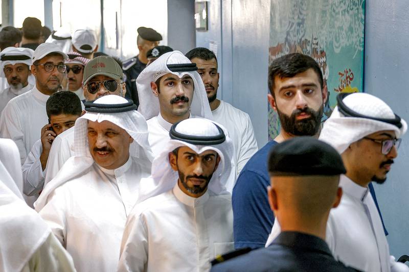 Voters queue at a polling station in Kuwait City on Tuesday. AFP
