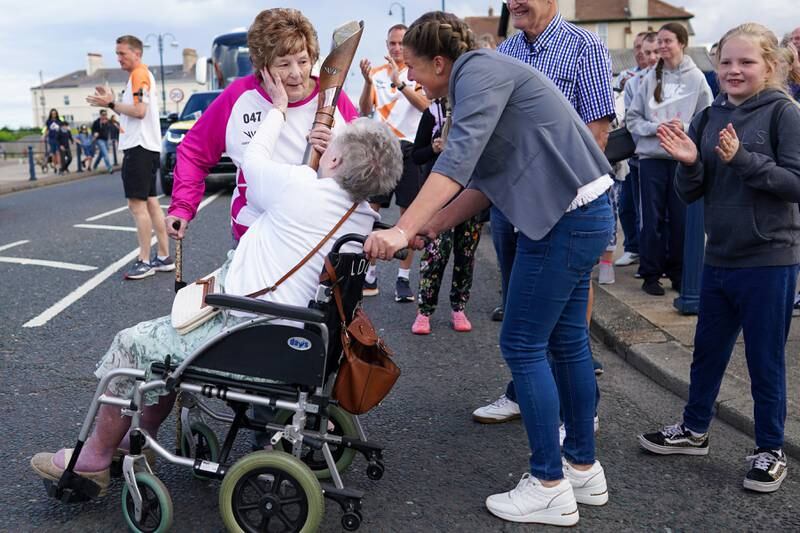 Jean Dixon is greeted by her mother, Jean Buck, 98, after she carried the baton through Seaham. Getty Images