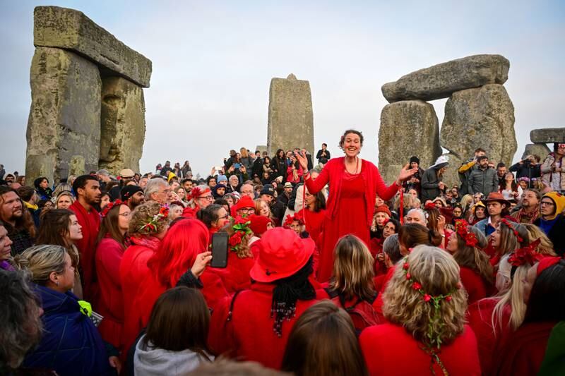 Thousands of people greet the summer solstice sunrise with cheers at Stonehenge. Getty Images