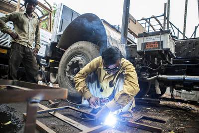 India has been struggling with slowing economic growth, high inflation levels and a weak currency. Above, a worker welds metal in New Delhi. Prashanth Vishwanathan / Bloomberg News