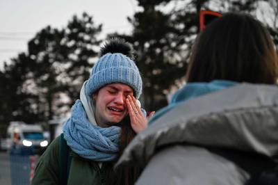 An Ukrainian girl in tears after crossing the border in Siret, northern Romania. AFP
