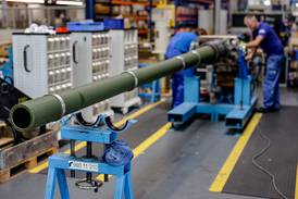 Technicians of German armaments company and automotive supplier Rheinmetall work on a 120mm cannon for Leopard battle tanks that will be delivered to Ukrainian forces. AFP