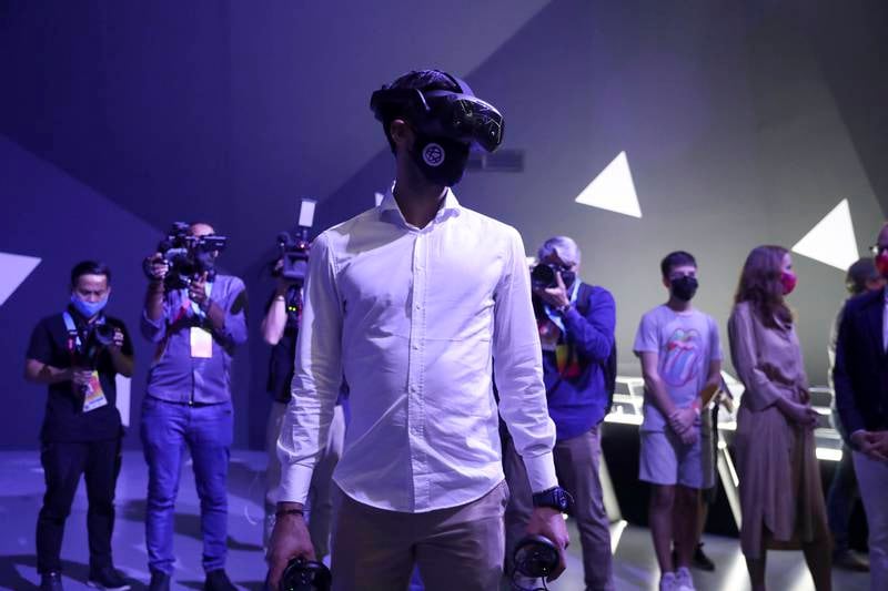 Novak Djokovic tries on a virtual reality headset at the Serbia Pavilion. Khushnum Bhandari / The National