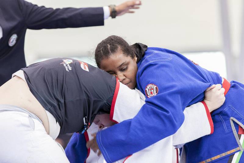 Salwa Al Ali, in blue, from the UAE, fights Juliana Oliveira, from Brazil during a Female White Adult +70 KG match at Al Ain Jiu Jitsu Open Championship. Reem Mohammed / The National