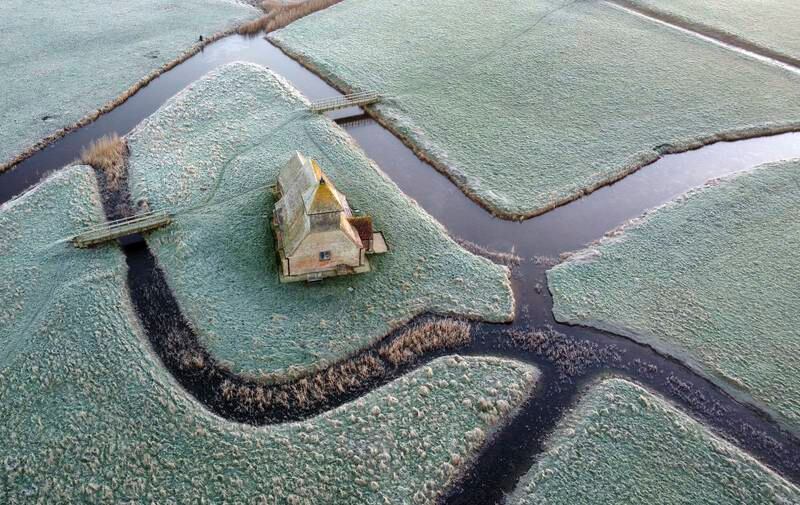 An aerial view of St Thomas Becket church, which dates back to 1200, in a frosty landscape, in Fairfield, Kent, southern England. PA