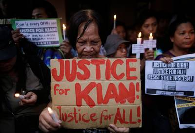epa06154441 Filipino sympathizers hold placards calling for justice for student Kian Loyd delos Santos who was allegedly killed under suspicious circumstances during a police anti-illegal drugs operation, at a wake in Kaloocan city, north of Manila, Philippines, 21 August 2017. Criticism of President Rodrigo Duterte's war on illegal drugs continues following the death of 17-year-old Filipino student Kian delos Santos who was killed during a police anti-drug operation on 16 August. Police claim delos Santos resisted authorities while witnesses cited by media reports claim that he was killed despite begging for his life.  EPA/FRANCIS R. MALASIG ATTENTION: GRAPHIC CONTENT
