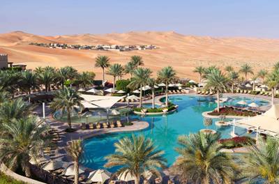 The lush pool area at Qasr Al Sarab
