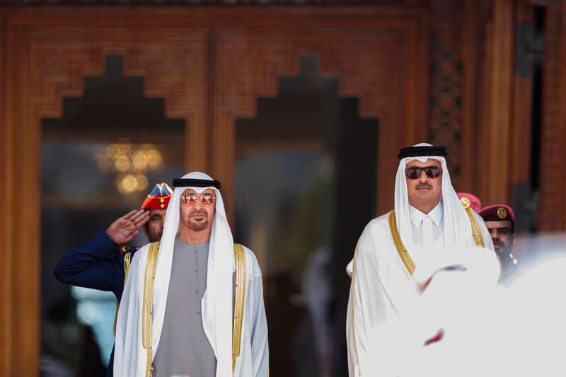Sheikh Mohamed and Sheikh Tamim stand for the national anthem during a reception at the Amiri Diwan. Abdulla Al Neyadi / Presidential Court 