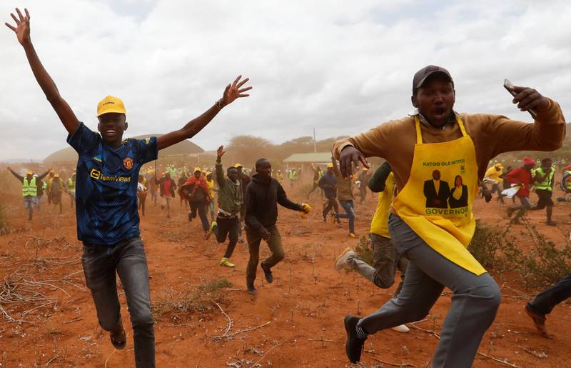 Supporters of Kenya's Deputy President William Ruto of the United Democratic Alliance and Kenya Kwanza political coalition run to meet him at Namanga on the Kenya-Tanzania border during a campaign tour for the presidential elections. Reuters