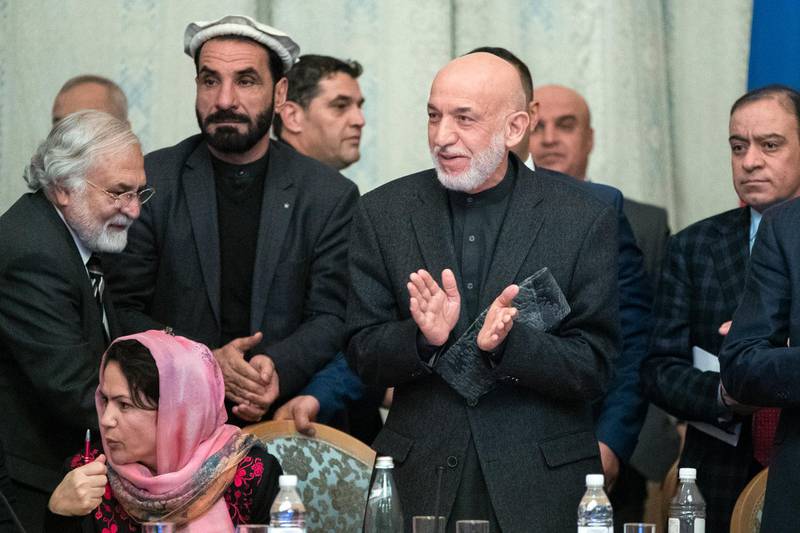 Former Afghan President Hamid Karzai, second from right, applauds during the "intra-Afghan" talks in Moscow, Russia, Wednesday, Feb. 6, 2019. The U.S. has promised to withdraw half of its troops from Afghanistan by the end of April, a Taliban official said Wednesday, but the U.S. military said it has received no orders to begin packing up. (AP Photo/Pavel Golovkin)