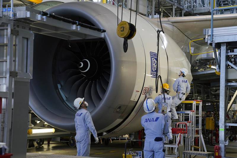 Technical staff members prepare one of the Rolls-Royce Holdings Plc engines of a Boeing Co. 787 Dreamliner aircraft operated by All Nippon Airways Co. (ANA) under maintenance in ANA's hanger at Haneda Airport in Tokyo, Japan, on Tuesday, April 27, 2021. ANA is scheduled to release earnings results on April 30. Photographer: Toru Hanai/Bloomberg