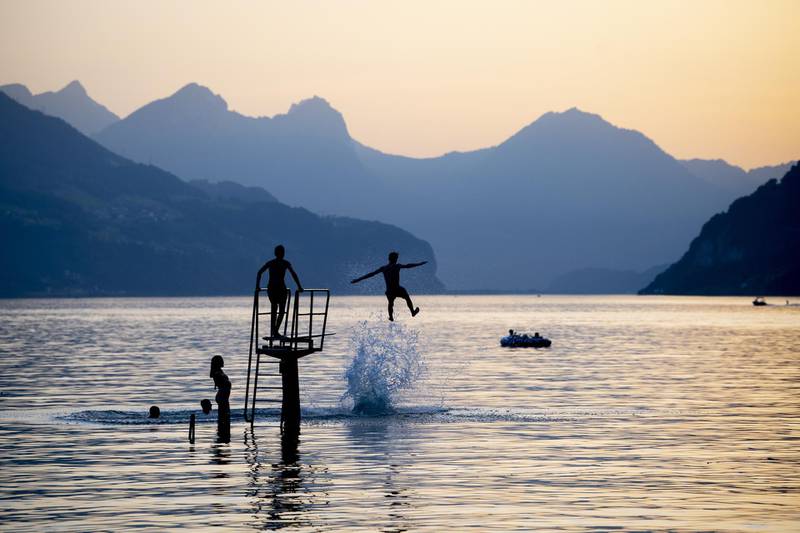 Youth enjoy the evening on lake Walensee in Walenstadt, Switzerland.  EPA