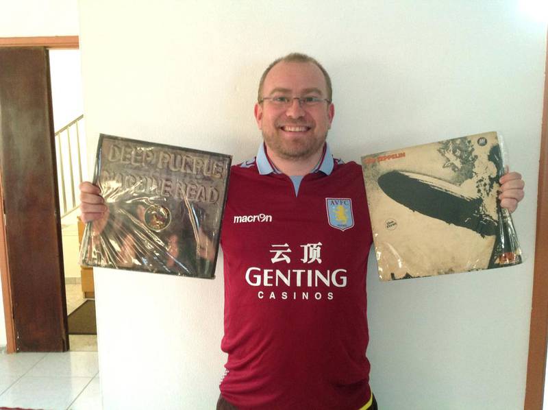 Jonathan Turner from the UK with his albums by Deep Purple and Led Zeppelin and wearing his Aston villa football top. Courtesy Jessica Hill