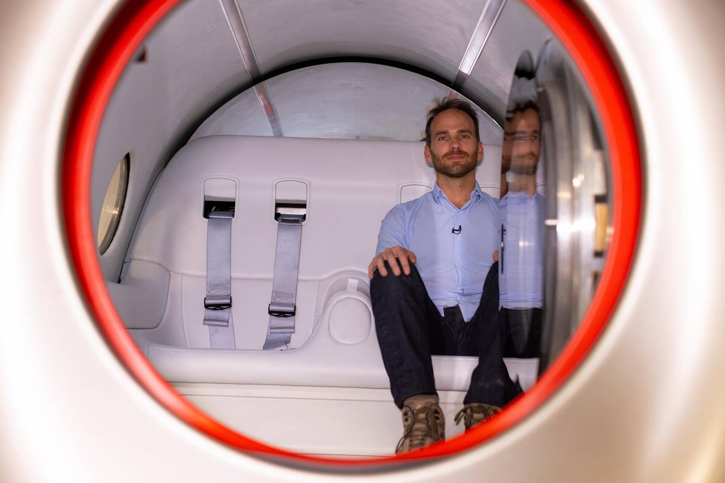Josh Giegel, co-founder and CEO of Virgin Hyperloop, poses inside a prototype pod at the company's hyperloop facility near Las Vegas, Nevada, May 5, 2021. Picture taken May 5, 2021. REUTERS/Mike Blake