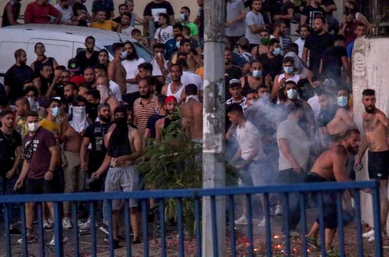 Supporters of Saad Hariri throw stones at the Lebanese Army during confrontations in Beirut. Hundreds gathered at major junctions and blocked the road to the city airport with burning tyres.