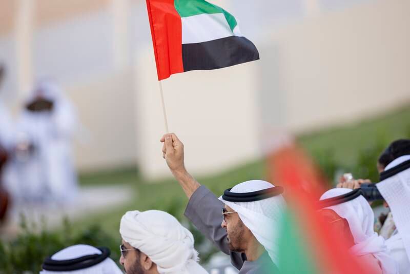 Sheikh Mohamed waves a UAE flag. Ryan Carter / Presidential Court 